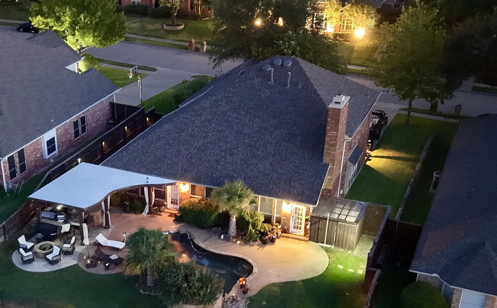 Home and backyard, lit at twilight